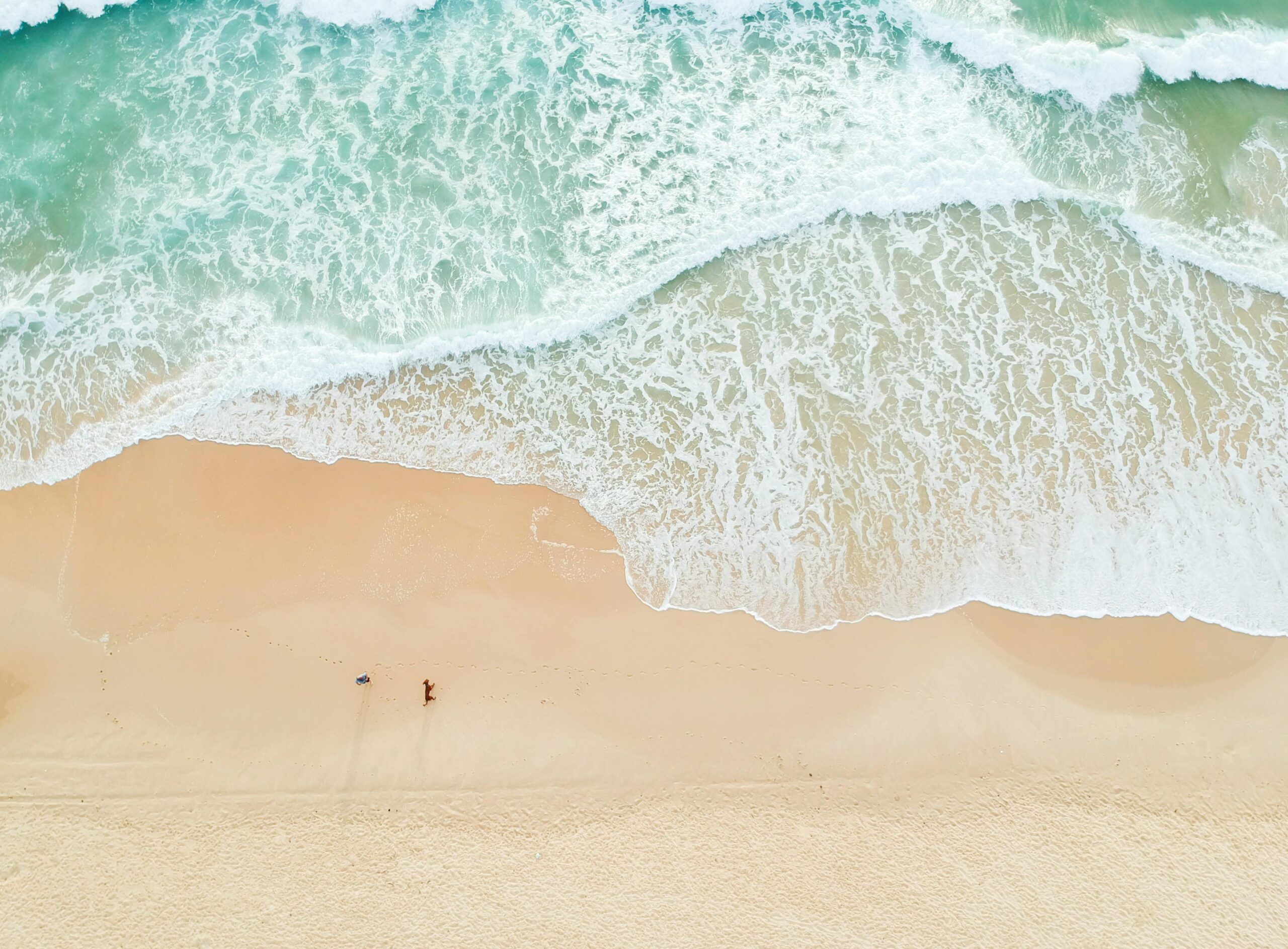 Serene aerial view of Castaways Beach in Queensland with gentle waves and sandy shores.